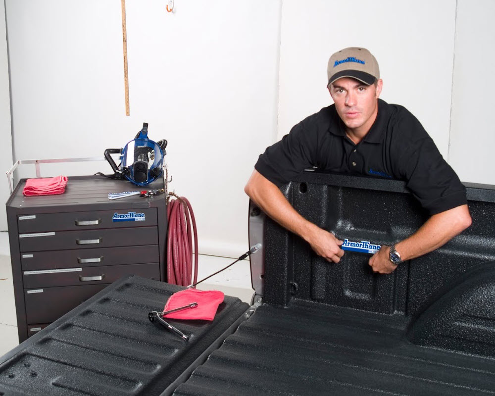 Professional applicator with a freshly sprayed bedliner